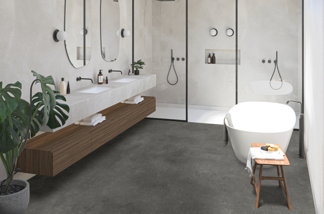 Modern ingerichte badkamer met betonlook vinylvloer, vrijstaand bad en dubbele inloopdouche